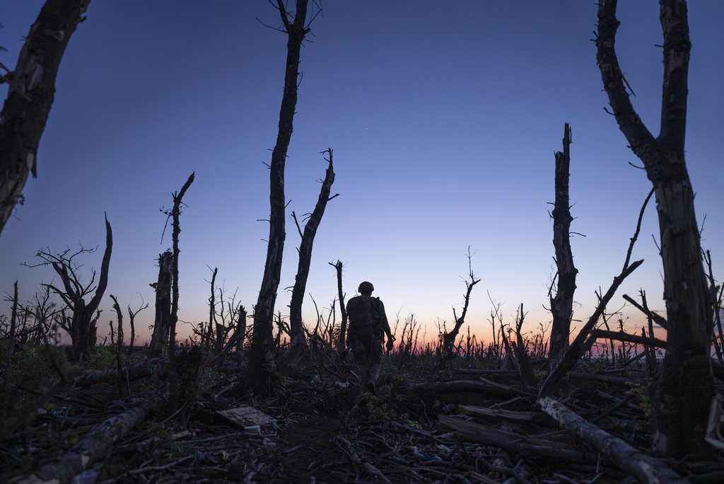 FILE - Ukrainian servicemen walk through a charred forest at the frontline a few kilometers from Andriivka, Donetsk region, Ukraine, Sept. 16, 2023. (AP Photo/Mstyslav Chernov, File)