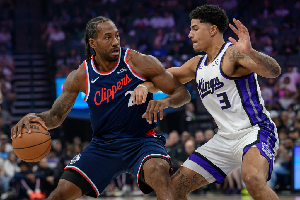 Los Angeles Clippers forward Kawhi Leonard (2) is guarded by Sacramento Kings guard Killian Hayes (3) during the first half of an NBA basketball game in Sacramento, Calif., Sunday, April 5, 2026. (AP Photo/Randall Benton)