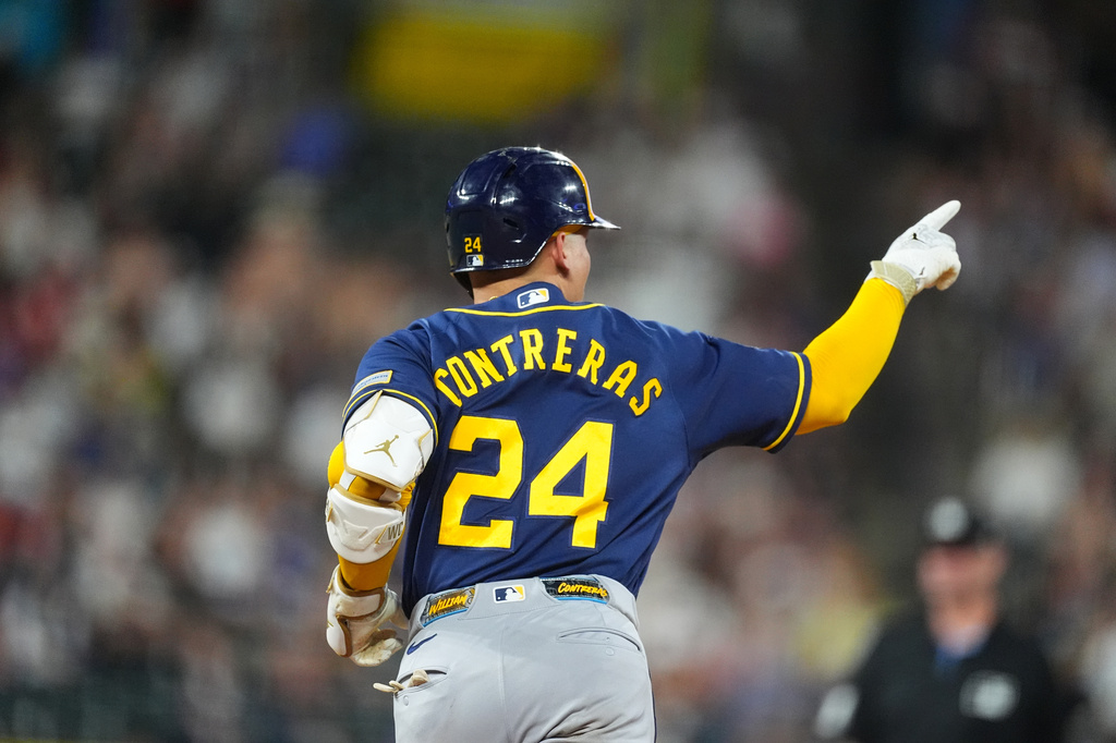 Milwaukee Brewers' William Contreras gestures to the bullpen as he rounds the bases after hitting a solo home run off Colorado Rockies relief pitcher Brennan Bernardino in the seventh inning of a baseball game Saturday, June 6, 2026, in Denver. (AP Photo/David Zalubowski)