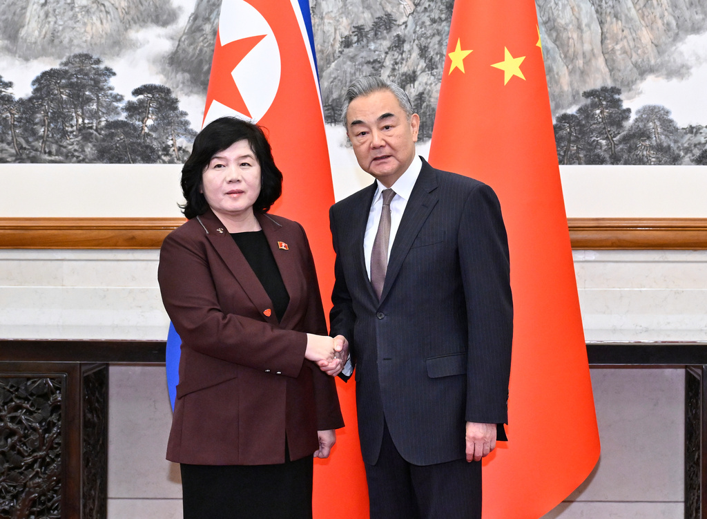 In this photo released by Xinhua News Agency, Chinese Foreign Minister Wang Yi, right, shakes hands with visiting North Korean counterpart Choe Son Hui prior to a meeting, in Beijing on Sunday, Sept. 28, 2025. (Yue Yuewei/Xinhua via AP)