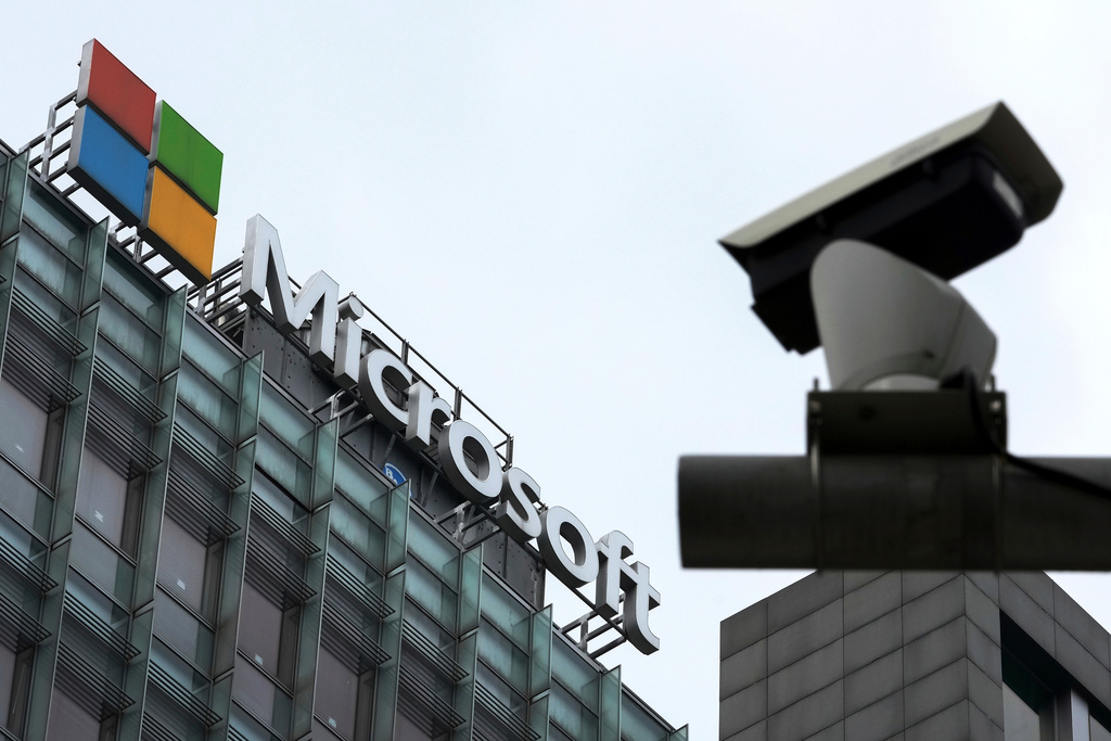 FILE - A security surveillance camera is seen near the Microsoft office building in Beijing, July 20, 2021. (AP Photo/Andy Wong, File)