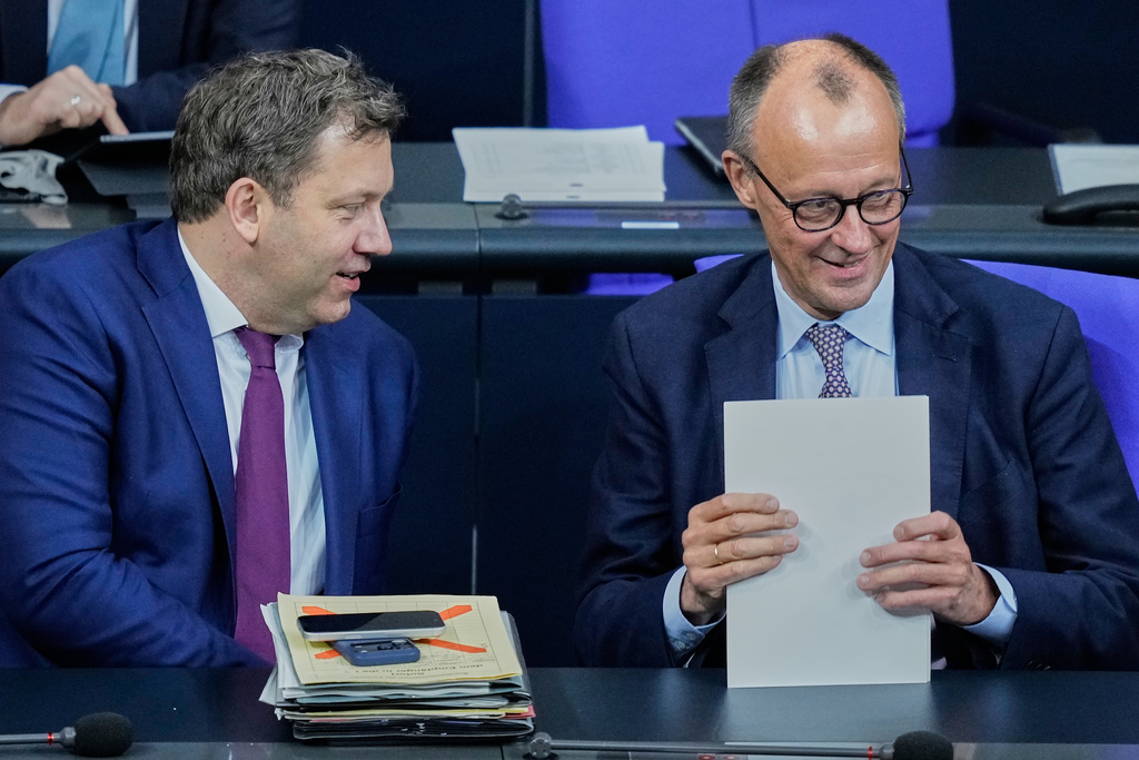 German Chancellor Friedrich Merz, right, and Vice Chancellor Lars Klingbeil attend a meeting about a pension package in the German Parliament in Berlin, Germany, Friday, Dec.5, 2025. (AP Photo/Ebrahim Noroozi)