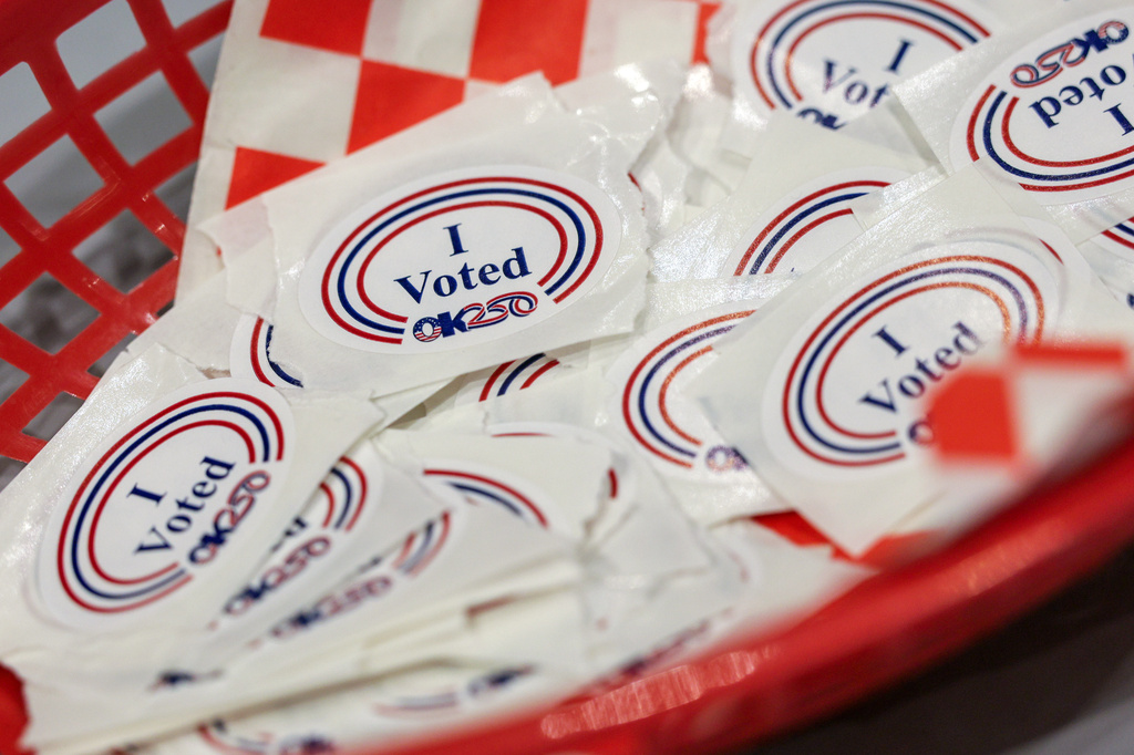 A basket holds stickers for voters at a polling location inside St. Luke's Methodist Church, Tuesday, June 16, 2026, in Oklahoma City. (AP Photo/Nate Billings)