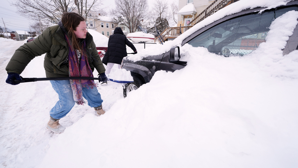 Emma Teske shovels out her car following a winter storm that dumped more than a foot and a half of snow across the region, Tuesday, Jan. 27, 2026, in Haverhill, Mass. (AP Photo/Charles Krupa)