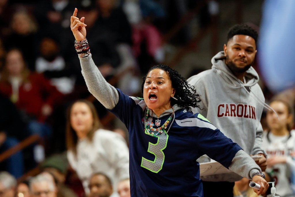South Carolina head coach Dawn Staley, front, signals for a review of an official's call during the first half of an NCAA college basketball game against Tennessee in Columbia, S.C., Sunday, Feb. 8, 2026. (AP Photo/Nell Redmond)