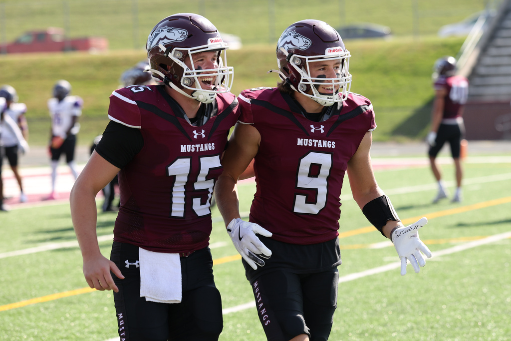 In this image provided by Morningside University Sports Information, Morningside wide receiver Drew Sellon (9) and quarterback Zack Chevalier celebrate during an NAIA college football game against Waldorf, Oct. 4, 2025, in Sioux City, Iowa. (Morningside University Sports Information via AP)