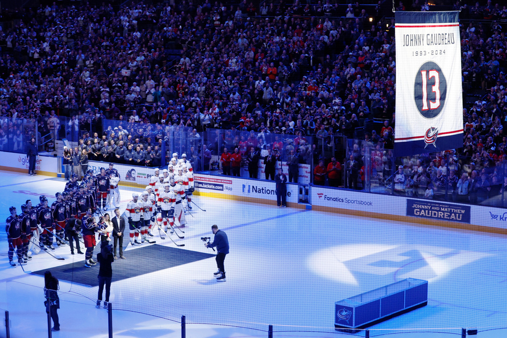 FILE - Blue Jackets' Johnny Gaudreau's family watches a #13 banner being raised during a ceremony before the start of an NHL hockey game between the Columbus Blue Jackets and the Florida Panthers. Tuesday, Oct. 15, 2024, in Columbus, Ohio. (AP Photo/Jay LaPrete, File)