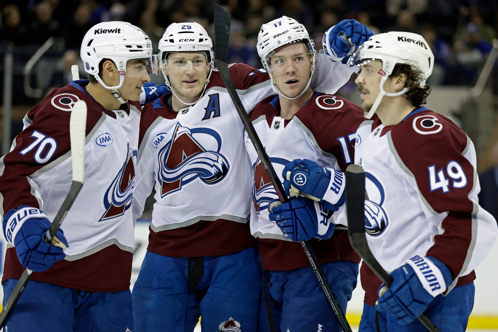 Colorado Avalanche center Parker Kelly (17) is congratulated by teammates after scoring a goal in the second period of an NHL hockey game against the New York Rangers, Saturday, Dec. 6, 2025, in New York. (AP Photo/Adam Hunger)