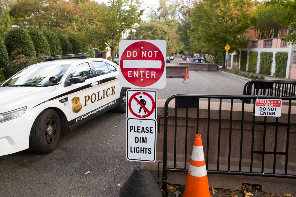FILE - An officer with the Uniform Division of the United States Secret Service sits in his car at a checkpoint near the home of President Barack Obama, Oct. 24, 2018, in Washington. (AP Photo/Alex Brandon, File)