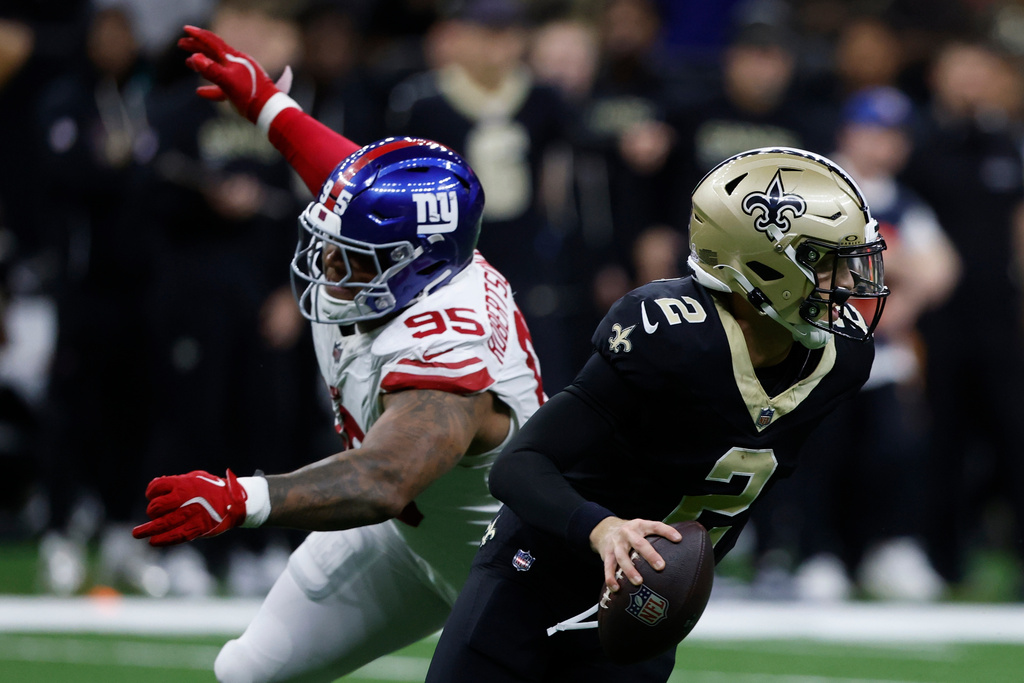 New York Giants defensive end Roy Robertson-Harris (95) pressures New Orleans Saints quarterback Spencer Rattler (2) in the second half of an NFL football game, Sunday, Oct. 5, 2025, in New Orleans.(AP Photo/Butch Dill)