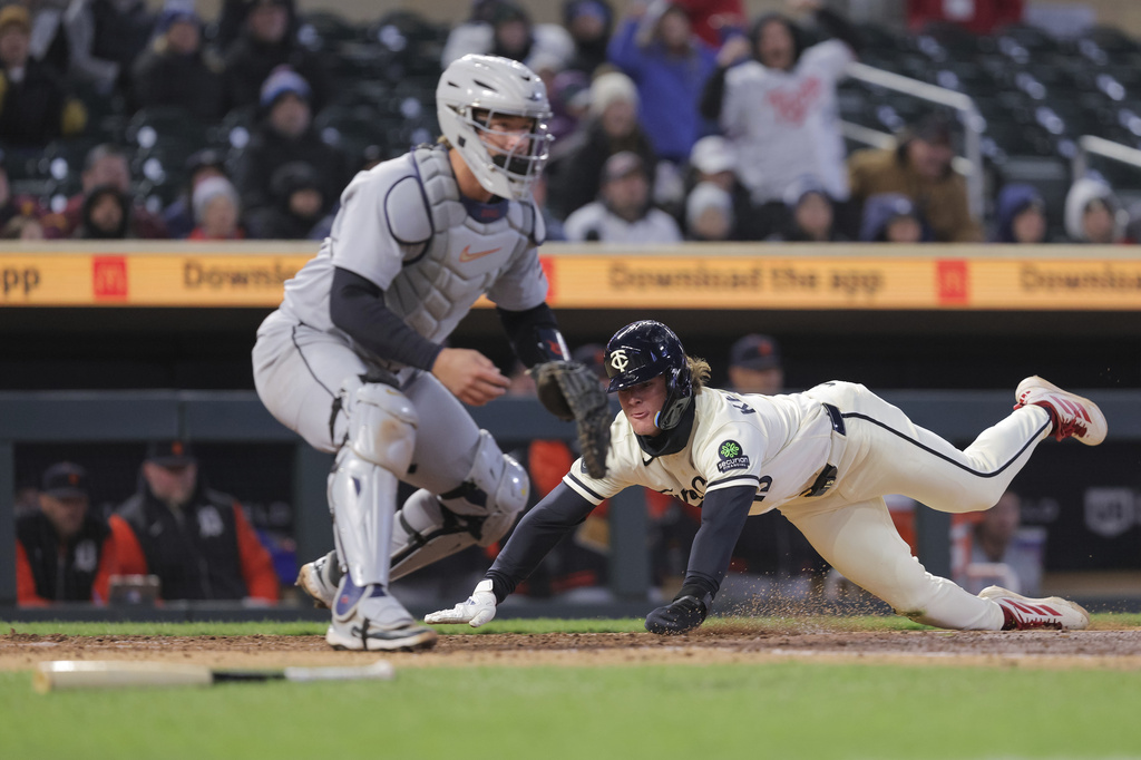 Minnesota Twins' Luke Keaschall, right, slides into home plate to score a run while Detroit Tigers catcher Dillon Dingler covers during the fifth inning of a baseball game Tuesday, April 7, 2026, in Minneapolis. (AP Photo/Bailey Hillesheim)