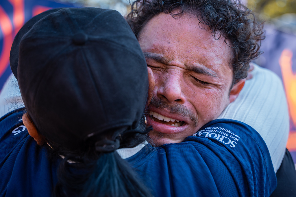 Broadway actor Anthony Ramos cries into his mother Mildred's arms after crossing the finish line of the New York City Marathon, Sunday, Nov. 2, 2025, in New York. (AP Photo/Angelina Katsanis)