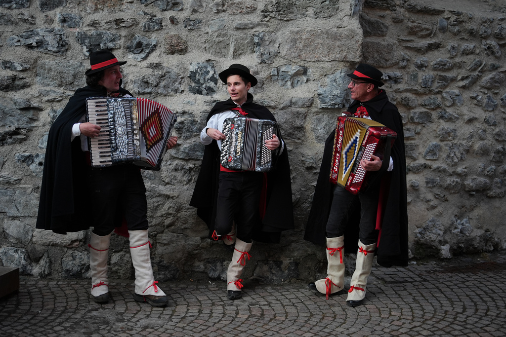 Accordion players, from left, Marco Compagnoni, Alberto Canclini, and Flavio Bottoni perform in the street in Bormio, Italy, during the 2026 Winter Olympics, Sunday, Feb. 8, 2026. (AP Photo/Rebecca Blackwell)