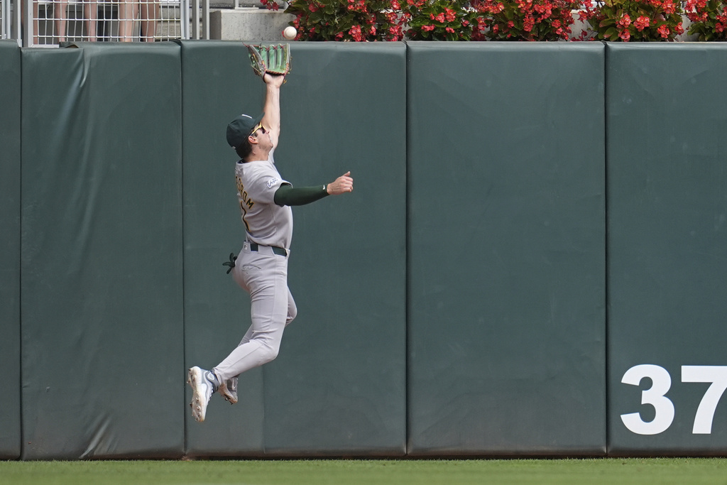 Athletics left fielder Tyler Soderstrom (21) tries to catch a double hit by Minnesota Twins' Royce Lewis (23) during the ninth inning of a baseball game Thursday, Aug. 21, 2025, in Minneapolis. (AP Photo/Abbie Parr)
