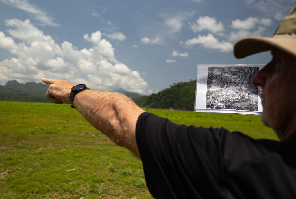 Andrew Snow, a researcher with the Thailand-Burma Railway Centre, uses historic aerial photographs from The National Archives in London to map out the layout of Nithe Station, a part of the infamous World War II "Death Railway," in Sangkhlaburi, Thailand on Saturday, May 30, 2026. (AP Photo/Anton L. Delgado)