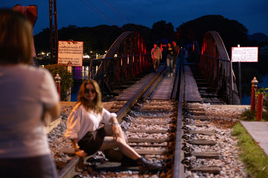 A visitor poses for a photo at the River Kwai Bridge, an iconic part of the infamous World War II "Death Railway," in Kanchanaburi, Thailand, Saturday, May 30, 2026. (AP Photo/Anton L. Delgado)