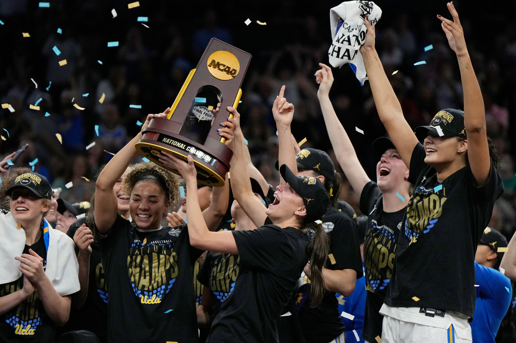 UCLA players celebrate after defeating South Carolina in the women's National Championship Final Four NCAA college basketball tournament game, Sunday, April 5, 2026, in Phoenix. (AP Photo/Ross D. Franklin)