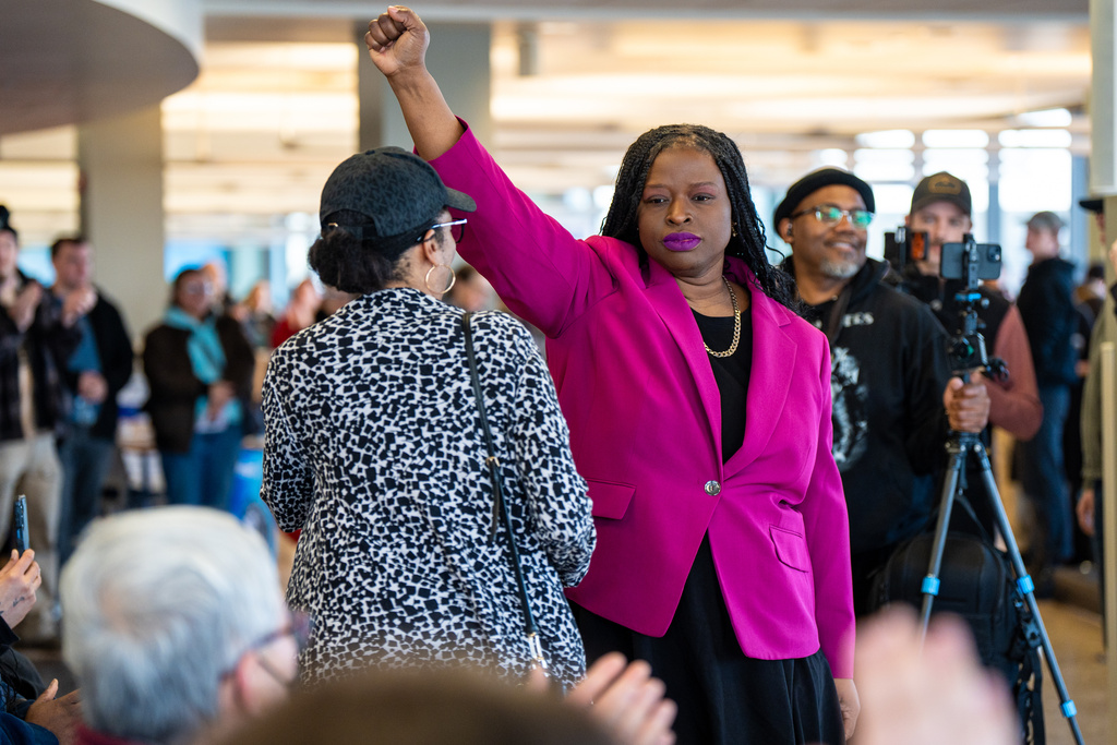 FILE - Nekima Levy Armstrong holds up her fist after speaking at an anti-ICE rally for Martin Luther King Jr., Monday, Jan. 19, 2026, in St. Paul, Minn. (AP Photo/Angelina Katsanis, File)