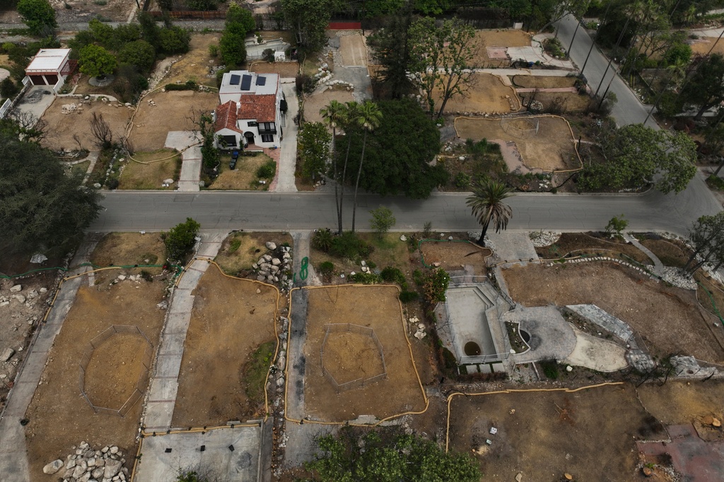 FILE - Lots sit empty after the homes were destroyed in the Eaton Fire in Altadena, Calif., June 4, 2025. (AP Photo/Jae C. Hong, File)