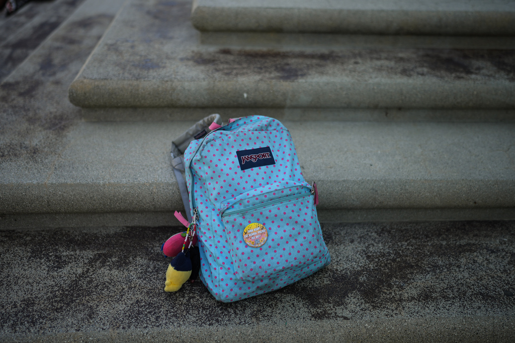 A backpack belonging to Makeda Walker-Deen, a junior at Susan Miller Dorsey Senior High School, sits on steps in Los Angeles, Thursday, May 14, 2026. (AP Photo/Jae C. Hong)