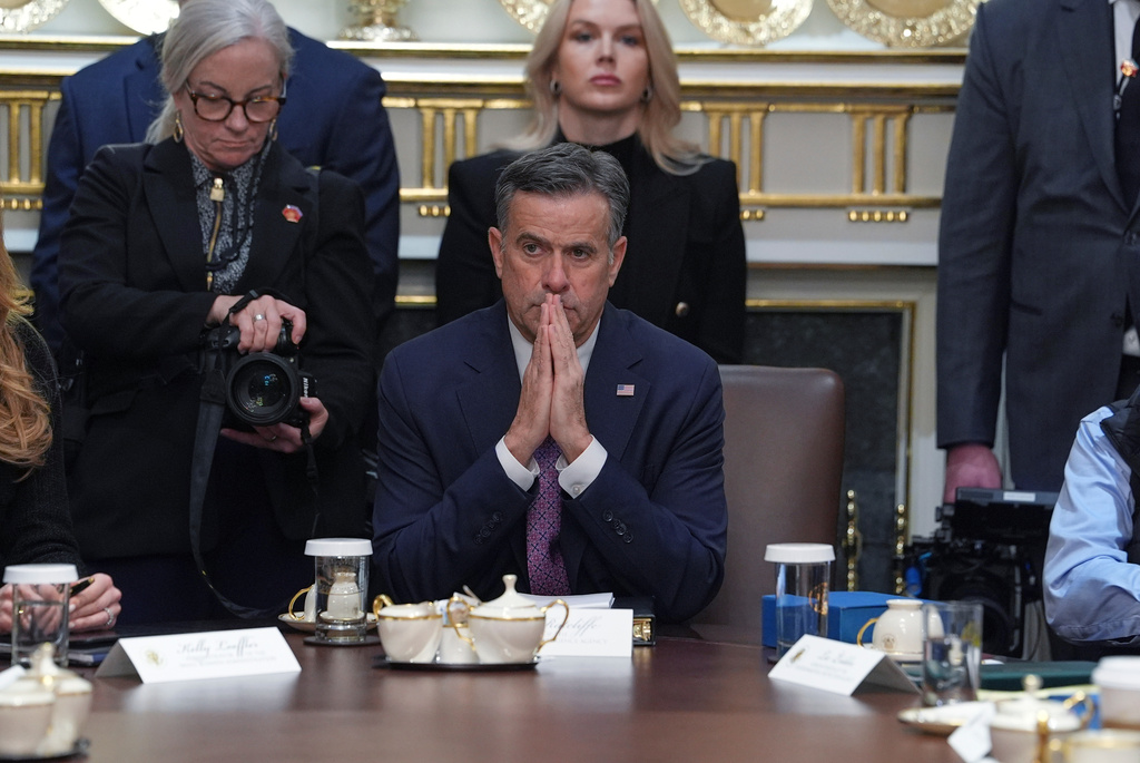CIA Director John Ratcliffe, seated at center, and White House press secretary Karoline Leavitt, standing in back, listen during a cabinet meeting at the White House, Thursday, Jan. 29, 2026, in Washington. (AP Photo/Evan Vucci)
