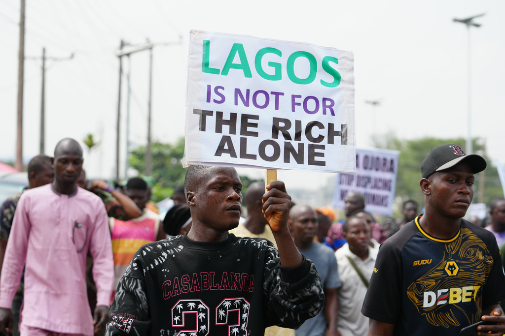 Victor Ahansu, center, protests the recent mass evictions and demolition of homes in Makoko and other communities, in Lagos, Nigeria, Wednesday, Jan. 28, 2026. (AP Photo/Sunday Alamba)
