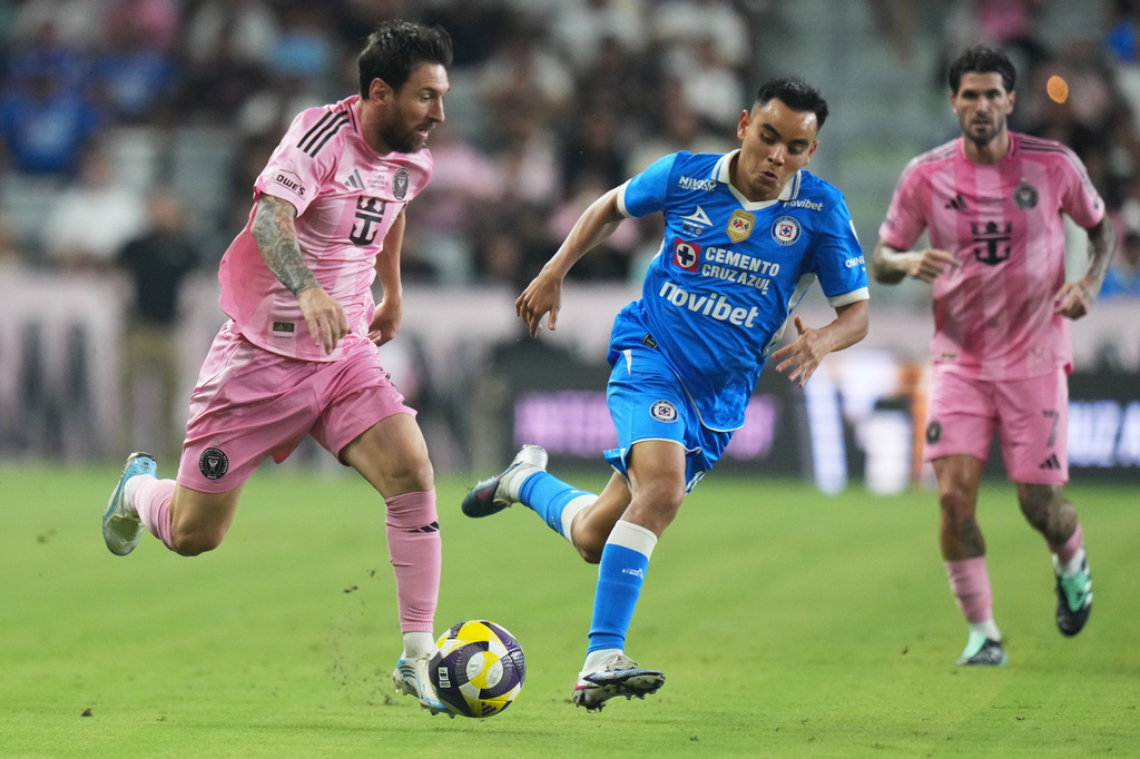 Inter Miami forward Leo Messi, left, runs with the ball as Cruz Azul midfielder Carlos Rodríguez defends during the first half of the Campeones Cup soccer match, Wednesday, Sept. 16, 2026, in Miami. (AP Photo/Lynne Sladky)