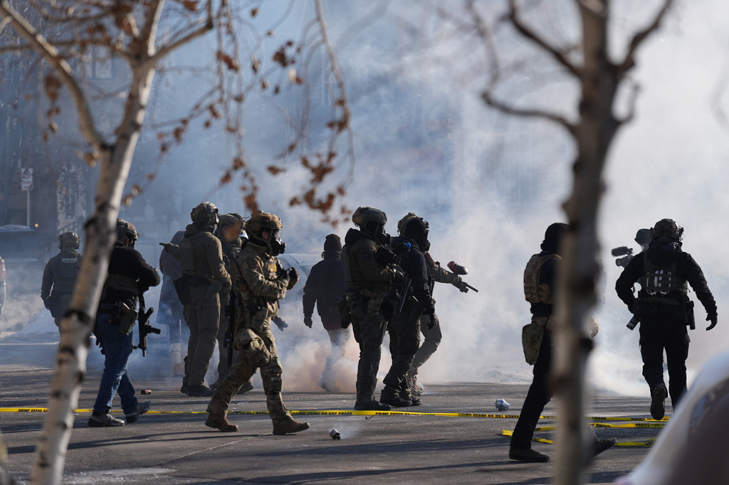 FILE - Federal immigration officers deploy tear gas at protesters after a shooting Jan. 24, 2026, in Minneapolis. (AP Photo/Abbie Parr, File)