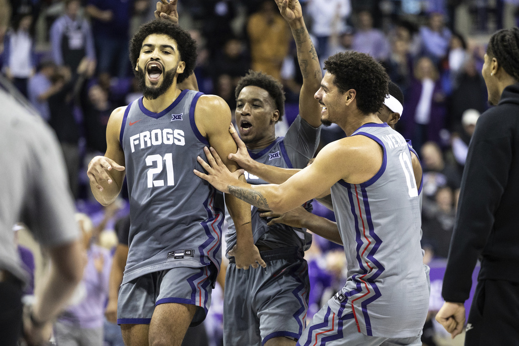TCU guard Noah Reynolds (21) celebrates with his team after making the game-winning shot at the end of the second half of an NCAA college basketball game against Kansas State, Saturday, Jan. 4, 2025, in Fort Worth, Texas. (Chris Torres/Star-Telegram via AP)