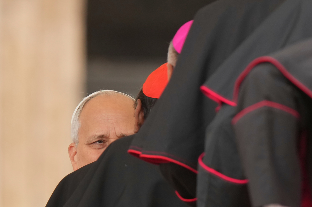 Pope Leo XIV is greeted by cardinals and bishops at the end of his weekly general audience in St. Peter's Square, at the Vatican, Wednesday, Oct. 7, 2026. (AP Photo/Andrew Medichini)