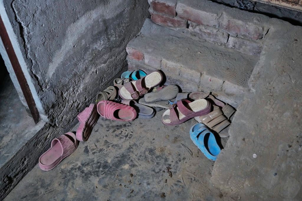 Slippers of the children left behind at the site of an under-construction tutoring center which collapsed, on the outskirts of Lahore, Pakistan, Tuesday, June 30, 2026. (AP Photo/K.M Chaudary)