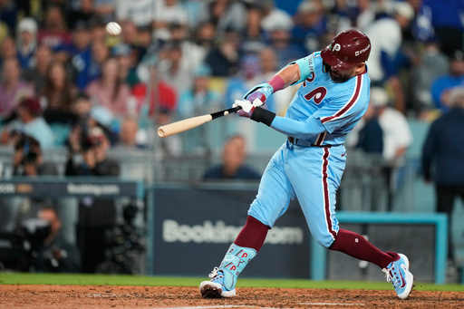 Philadelphia Phillies' Kyle Schwarber connects for a two-run home run during the eighth inning in Game 3 of baseball's National League Division Series against the Los Angeles Dodgers, Wednesday, Oct. 8, 2025, in Los Angeles. (AP Photo/Mark J. Terrill) Philadelphia Phillies' Kyle Schwarber connects for a two-run home run during the eighth inning in Game 3 of baseball's National League Division Series against the Los Angeles Dodgers, Wednesday, Oct. 8, 2025, in Los Angeles. (AP Photo/Mark J. Terrill)