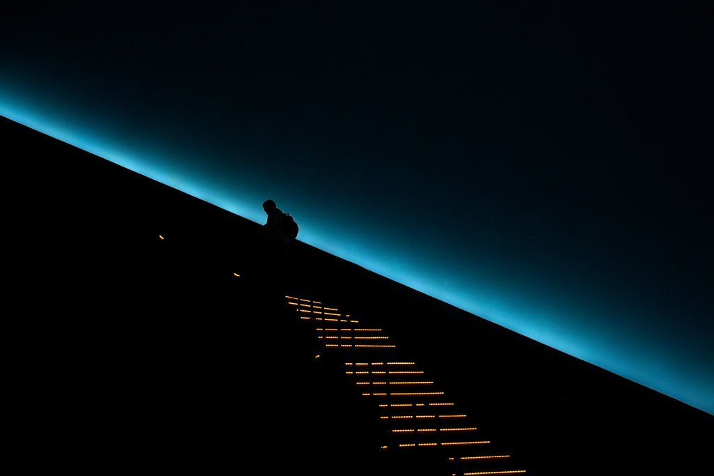 A patron climbs to their seat before a viewing of "Ohio: Wild at Heart" film that features the state's top-rated park system to highlight wildlife conservation efforts and the restorative power of outdoor recreation at the Robert D. Lindner Family OMNIMAX Theater at the Cincinnati Union Terminal, Tuesday, Dec. 30, 2025, in Cincinnati. (AP Photo/Carolyn Kaster)