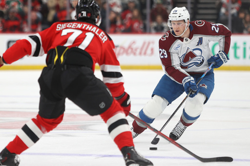 Colorado Avalanche's Nathan MacKinnon, right, skates with the puck against New Jersey Devils' Jonas Siegenthaler, left, during the first period of an NHL hockey game Sunday, Oct. 26, 2025, in Newark, N.J. (AP Photo/Pamela Smith) Colorado Avalanche's Nathan MacKinnon, right, skates with the puck against New Jersey Devils' Jonas Siegenthaler, left, during the first period of an NHL hockey game Sunday, Oct. 26, 2025, in Newark, N.J. (AP Photo/Pamela Smith)