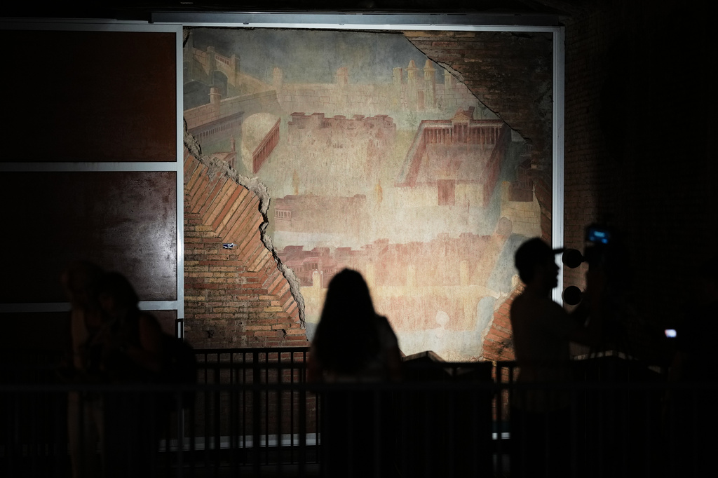 Reporters film the "The Painted City" fresco, discovered during 1990s built as foundations for the Baths of Trajan that has been restored, in Rome, Tuesday, Sept. 8, 2026.(AP Photo/Andrew Medichini)