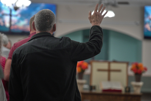 A congregant raises his hand Sunday, Oct. 12, 2025, at Maple Valley Baptist Church in McEwen, Tenn., about 3 miles from Accurate Energetic Systems, an explosives plant where a blast Friday killed 16 people. (AP Photo/Obed Lamy) A congregant raises his hand Sunday, Oct. 12, 2025, at Maple Valley Baptist Church in McEwen, Tenn., about 3 miles from Accurate Energetic Systems, an explosives plant where a blast Friday killed 16 people. (AP Photo/Obed Lamy)