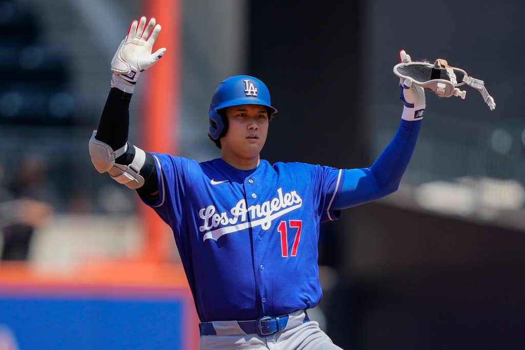 Los Angeles Dodgers designated hitter Shohei Ohtani gestures after hitting a double during the first inning of a baseball game against the New York Mets, Sunday, July 26, 2026, in New York. (AP Photo/Yuki Iwamura)