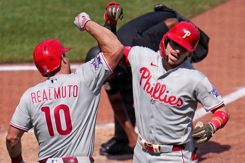 Philadelphia Phillies' Bryson Stott, right, celebrates with J.T. Realmuto (10) as he heads to the dugout after hitting a solo home run off Pittsburgh Pirates pitcher Dennis Santana during the eighth inning of a baseball game in Pittsburgh, Sunday, May 17, 2026. (AP Photo/Gene J. Puskar)