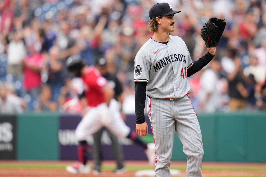 Minnesota Twins pitcher Joe Ryan (41) waits for a new ball as Cleveland Guardians' Rhys Hoskins, left, runs the bases after hitting a home run in the first inning of a baseball game in Cleveland, Monday, July 20, 2026. (AP Photo/Sue Ogrocki)