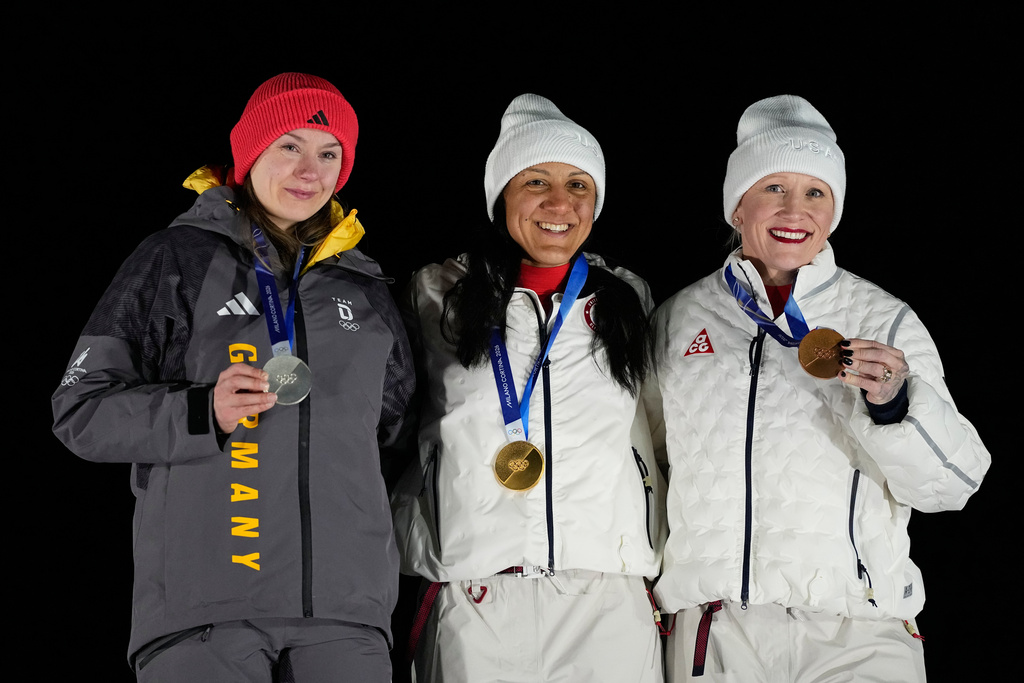 From left, Germany's silver medalist Laura Nolte, United States' gold medalist Elana Meyers Taylor and United States' bronze medalist Kaillie Armbruster Humphries pose for photos on the podium of a women's monobob competition at the 2026 Winter Olympics, in Cortina d'Ampezzo, Italy, Monday, Feb. 16, 2026. (AP Photo/Alessandra Tarantino)