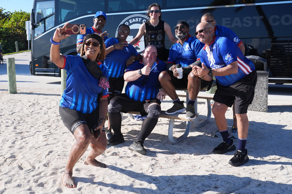 U.S. Army veteran Sabrina Bradley, left, takes a group photo at the Veterans Memorial Park after riding in the annual Florida Keys Soldier Ride organized by the Wounded Warrior Project, Friday, Jan. 9, 2026, in Little Duck Key, Fla. (AP Photo/Lynne Sladky)