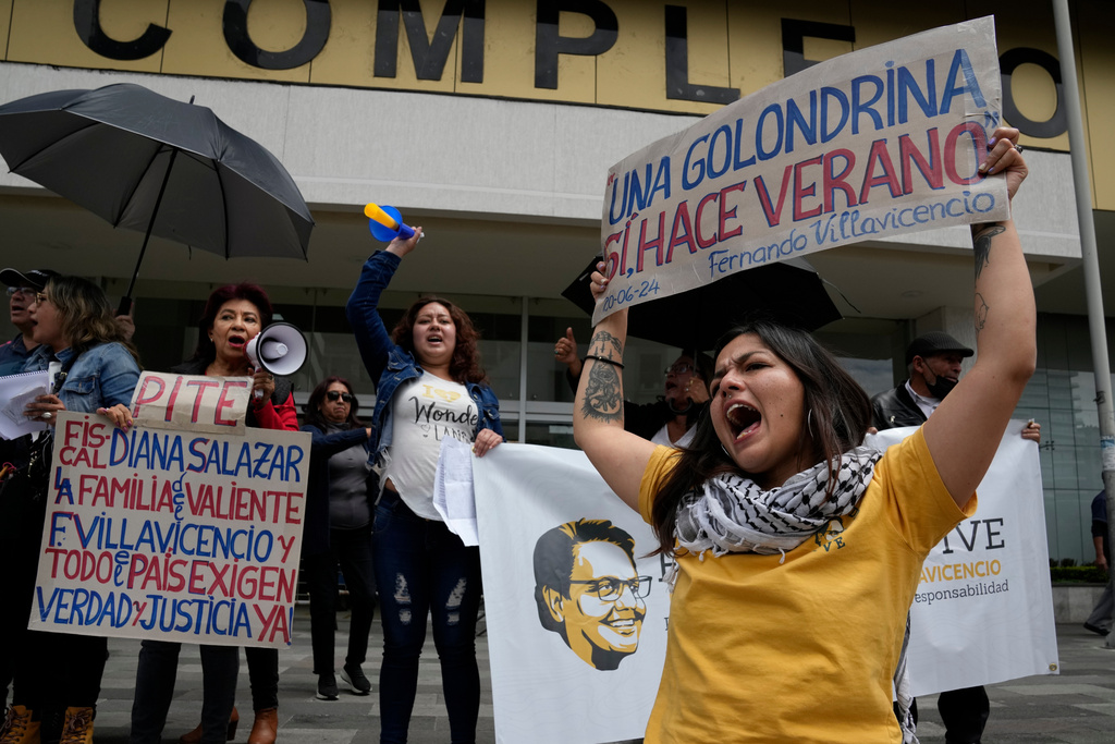 FILE - Amanda Villavicencio, the daughter of murdered presidential candidate Fernando Villavicencio, protests with other members of her family outside the court where suspects in her father's murder are being tried, in Quito, Ecuador, June 27, 2024. (AP Photo/Dolores Ochoa, File)