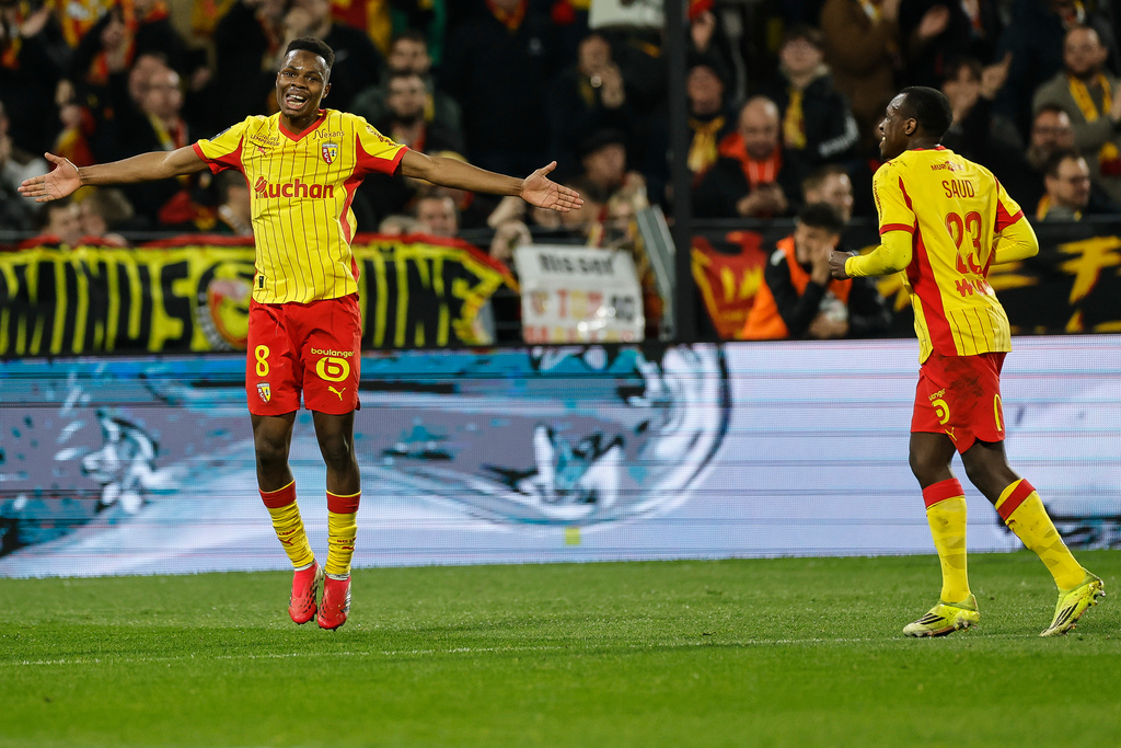 Lens' Sangare Mamadou, left, reacts after scoring during the French League One soccer game between Lens and Angers, Friday, March 20,2 026, in Lens, France. (AP Photo/Jean-Francois Badias)