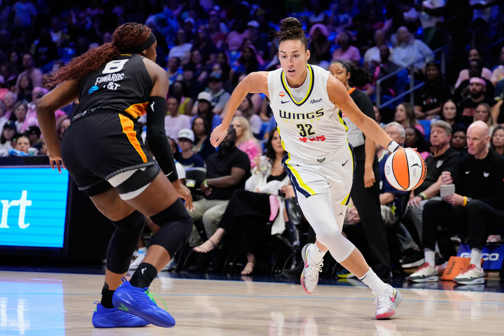 Dallas Wings forward Jessica Shepard (32) drives to the basket as Connecticut Sun's Aaliyah Edwards (8) defends in the first half of a WNBA basketball game Sunday, Aug. 30, 2026, in Arlington, Texas. (AP Photo/Tony Gutierrez)