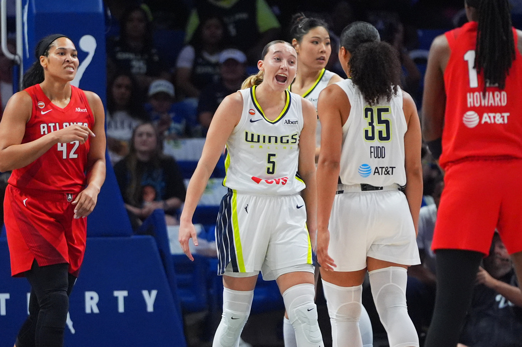 Dallas Wings guard Paige Bueckers (5) reacts with teammate guard Azzi Fudd (35) as Atlanta Dream forward Brionna Jones (42) looks on during the first half of a WNBA basketball game in Arlington, Texas, Wednesday, July 29, 2026. (AP Photo/LM Otero)