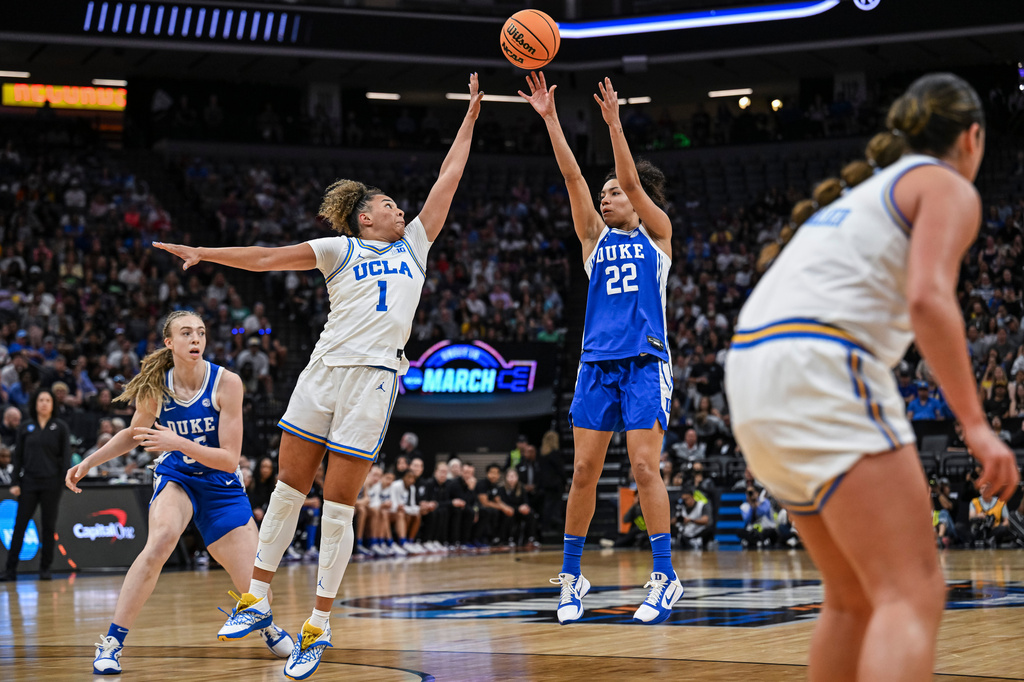 Duke guard Taina Mair (22) shoots over UCLA guard Kiki Rice (1) during the first half in the Elite Eight of the NCAA college basketball tournament Sunday, March 29, 2026, in Sacramento, Calif. (AP Photo/Justine Willard)
