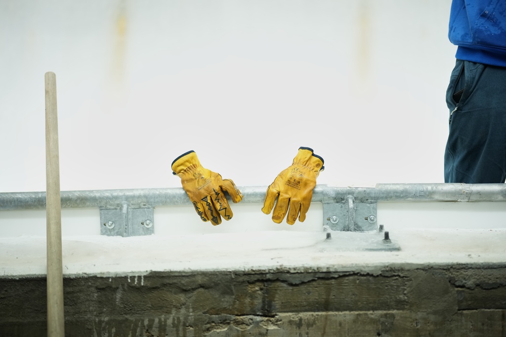 A worker's gloves and tool are lined up along the track ahead of a three-day skeleton and bobsled World Cup stage and Olympic test event in Cortina D'Ampezzo, Italy, Wednesday, Nov. 19, 2025. (AP Photo/Andrew Medichini)