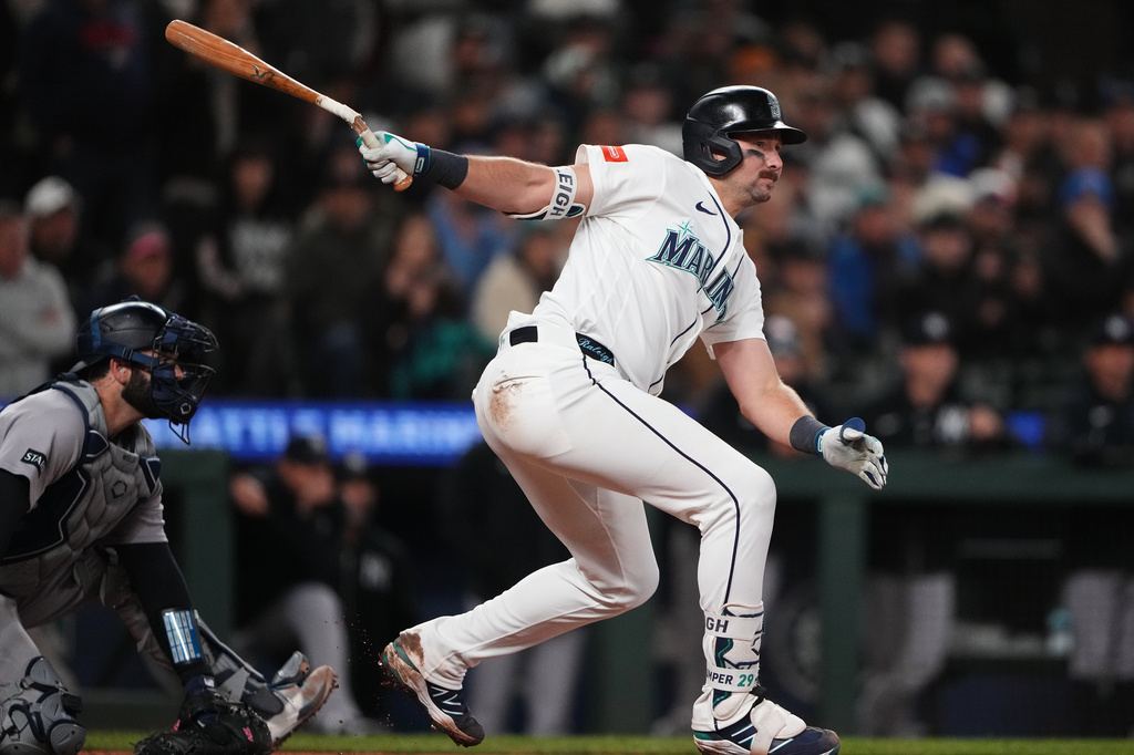 Seattle Mariners' Cal Raleigh follows through on a two-run single against the New York Yankees during the eighth inning of a baseball game, Wednesday, April 1, 2026, in Seattle. (AP Photo/Lindsey Wasson)