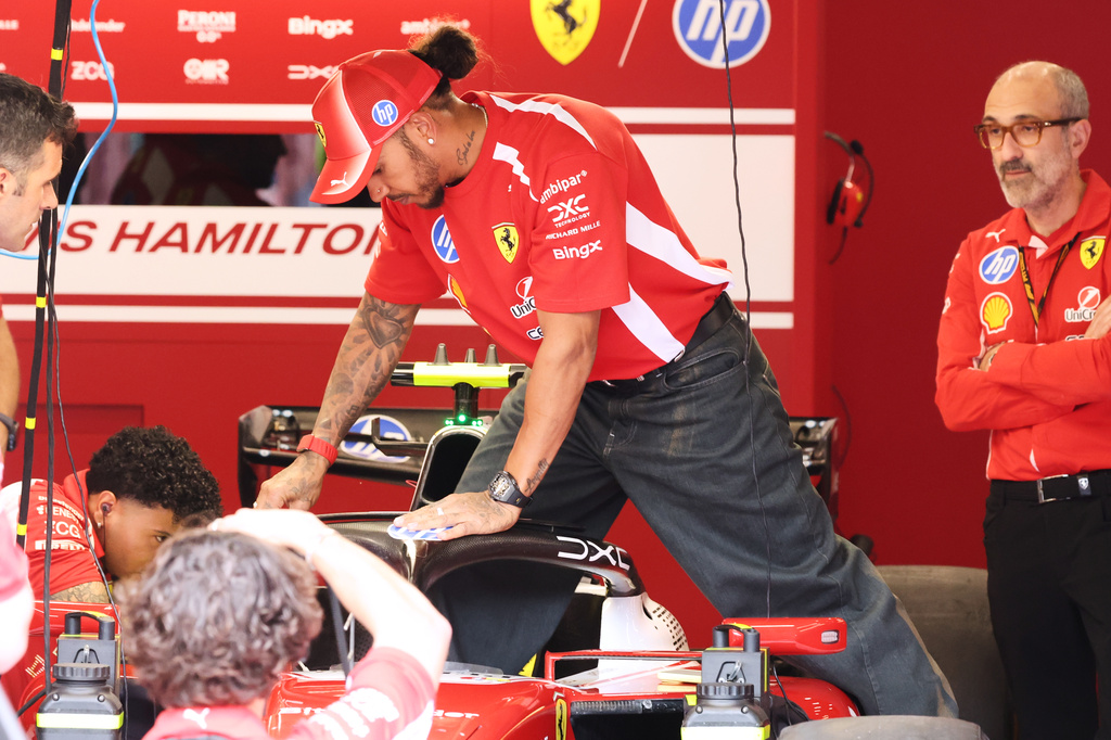 Ferrari driver Lewis Hamilton of Britain steps into his car in the team garage ahead of the Formula One Grand Prix at the Spa-Francorchamps racetrack in Spa, Belgium, Thursday, July 16, 2026. (AP Photo/Omar Havana)