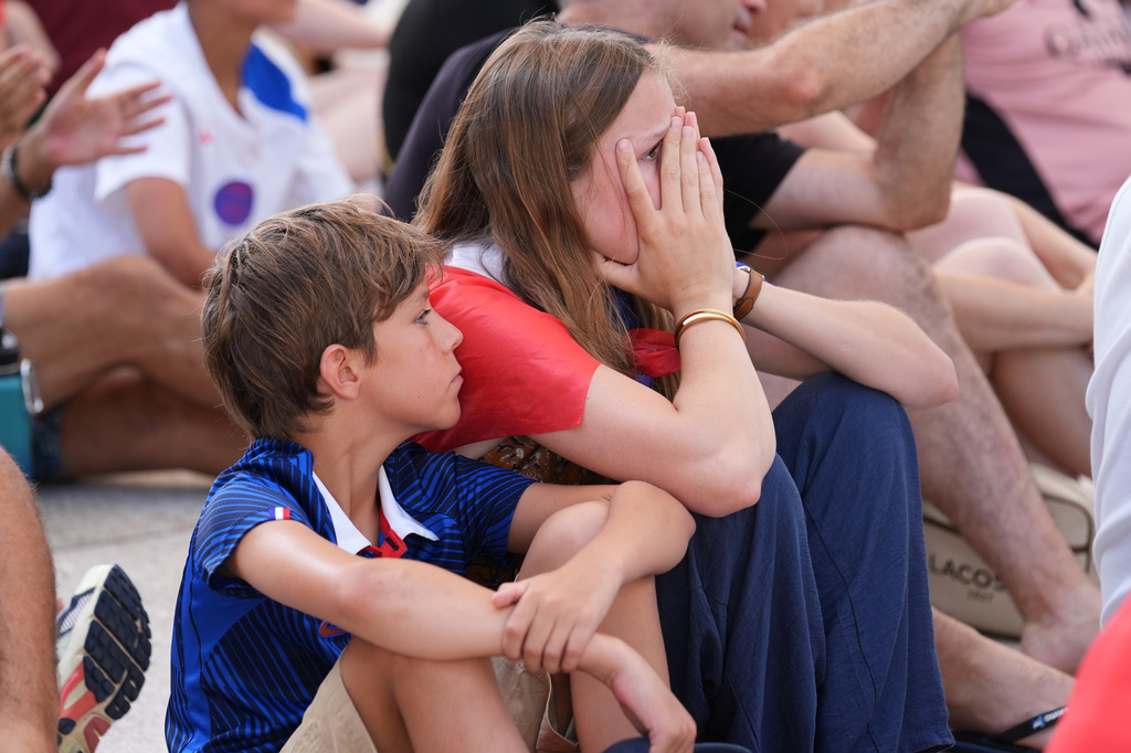Marie Dalnard and her brother Alexander, 11, watch as France falls behind Spain at a World Cup semifinal soccer watch party, Tuesday, July 14, 2026, in Miami Beach, Fla. (AP Photo/Marta Lavandier)